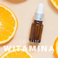 Serum z witaminą C na twarz, otoczone soczystymi plastrami pomarańczy.