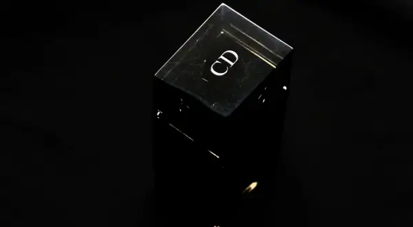 Czarny, szklany flakonik perfum z logo "CD". Czy perfumy mają datę ważności? Ten flakonik wygląda na wieczny.