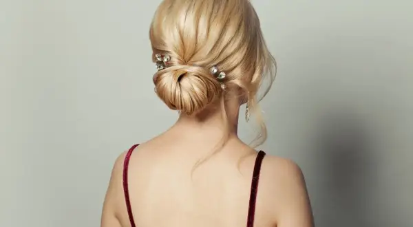 Eleganckie, luźne upięcia włosów do ramion z błyszczącymi spinkami. Delikatne pasma opadają na ramiona, tworząc romantyczny look.