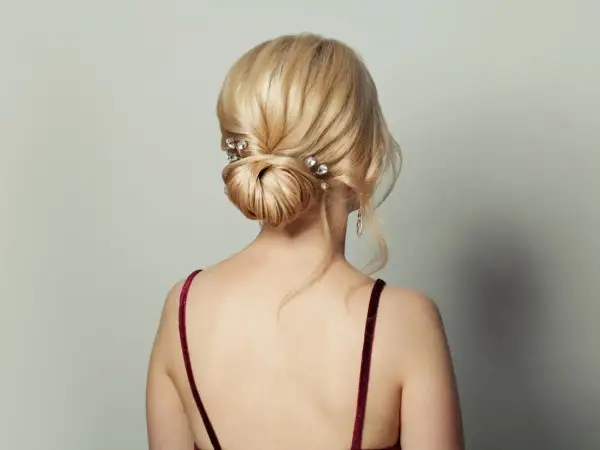 Eleganckie, luźne upięcia włosów do ramion z błyszczącymi spinkami. Delikatne pasma opadają na ramiona, tworząc romantyczny look.